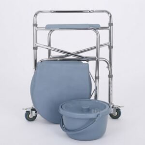The chrome and grey folding commode chair from image 1 is shown in its fully collapsed, compact state, leaning against a white wall with its detached pail positioned in front.