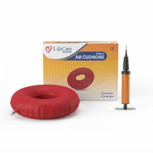 A retail box for "LifeCare Medical AIR CUSHIONS" is shown behind a fully inflated red donut cushion and an orange hand pump on a white background.