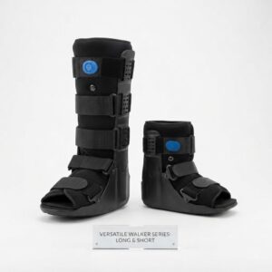 Product photograph showing a side-by-side comparison of a long and a short orthopedic pneumatic walker boot, both black with blue air valves and adjustable straps, displayed on a white background with a descriptive acrylic plaque