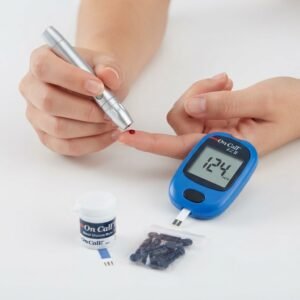 Close-up of a person using the silver lancing device to prick a finger, with the On Call EZ II meter nearby.